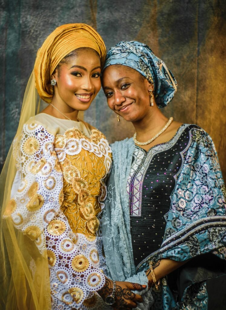 Warm portrait of two women in vibrant traditional attire, symbolizing friendship.